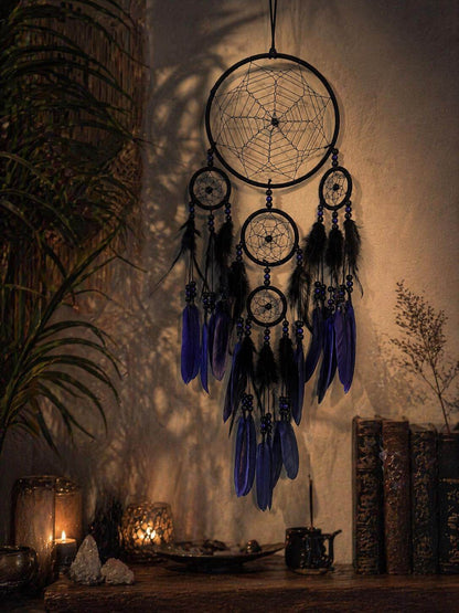 Decorative dreamcatcher with blue feathers on a mystical table setting.