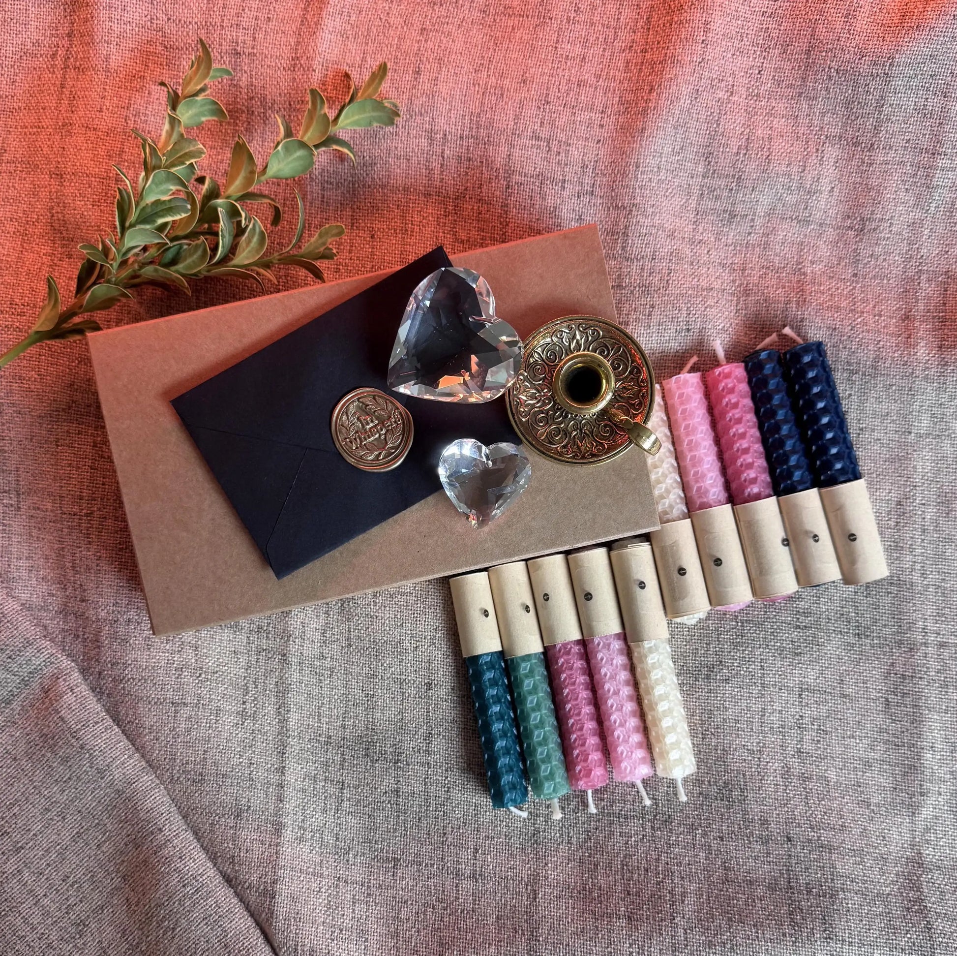 Set of decorative candles with natural beeswax on a textured fabric background