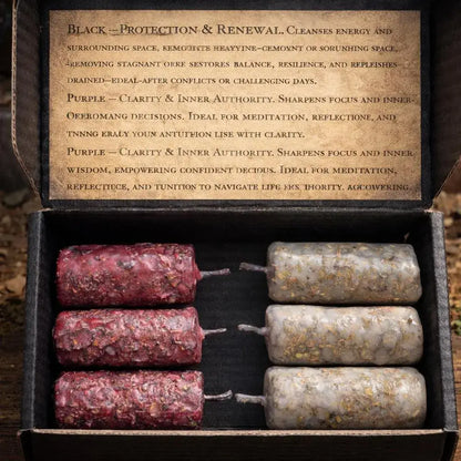 An open black box containing four herbal wax melts: three in dark reddish-brown paper and one in light beige paper, with the inner lid showing printed descriptions of their properties.