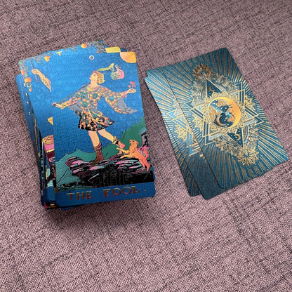 Two tarot cards on a textured surface, one open showing 'The Fool' card.