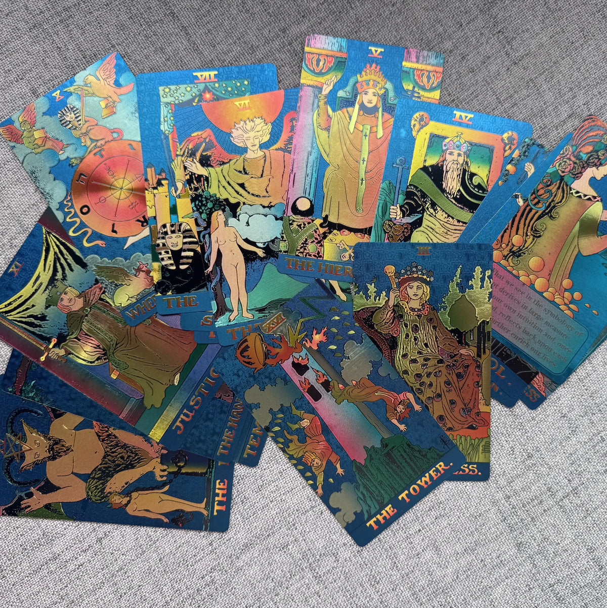 Colorful tarot cards spread out on a textured surface