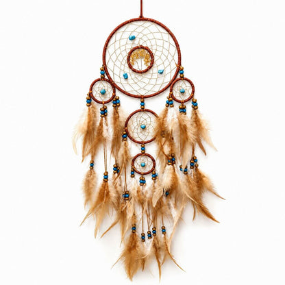 Dreamcatcher with feathers and beads on a white background